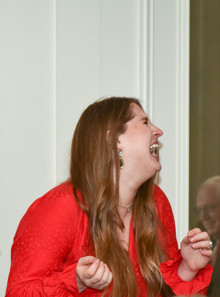 lady laughing at service club magic program